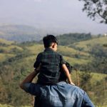 father and son enjoy scenic nature view