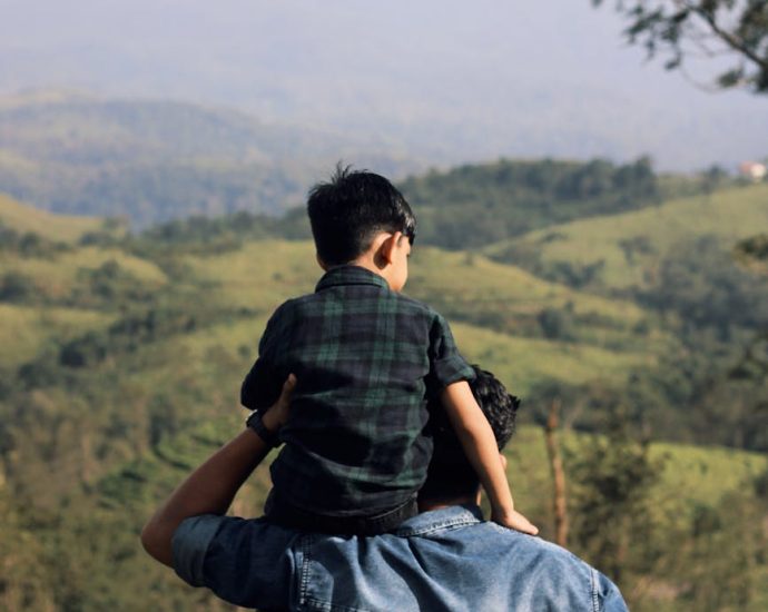 father and son enjoy scenic nature view