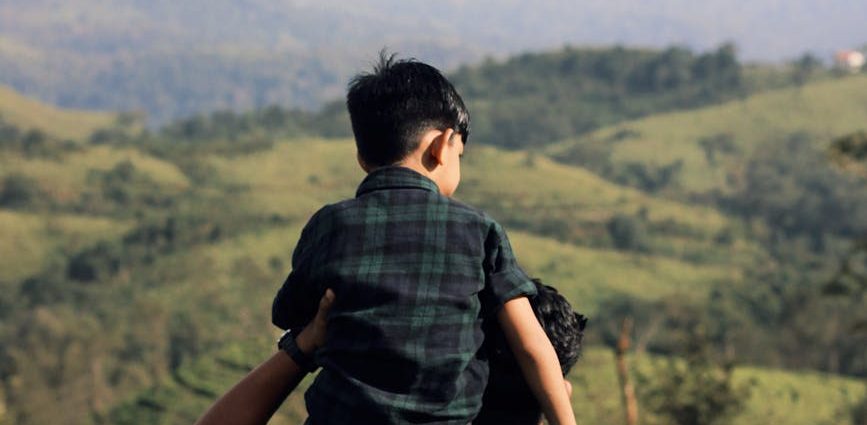 father and son enjoy scenic nature view