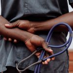 a medical person holding a stethoscope