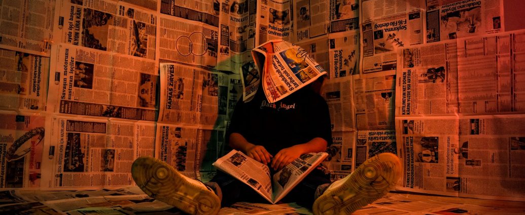 person in newspaper room with creative lighting