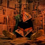 person in newspaper room with creative lighting