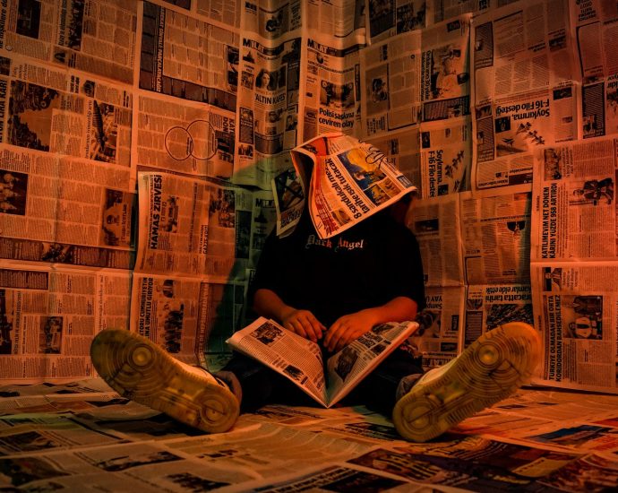 person in newspaper room with creative lighting