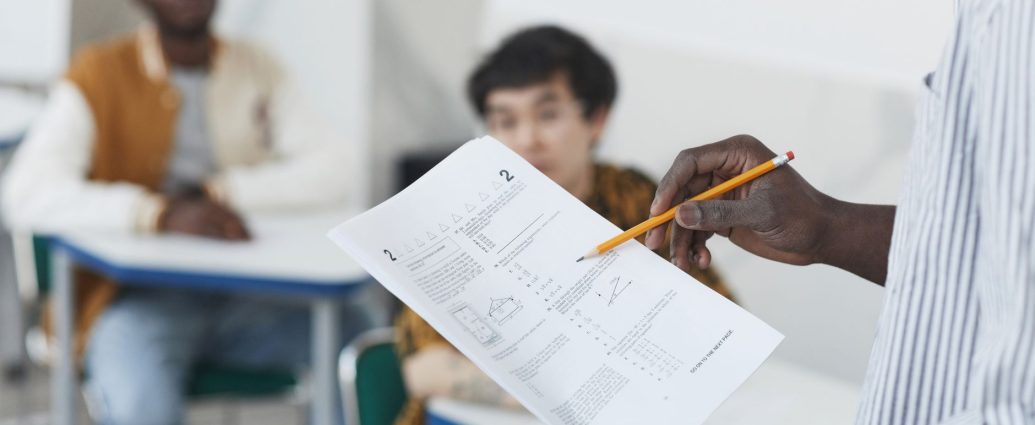 a person holding test papers