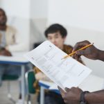 a person holding test papers