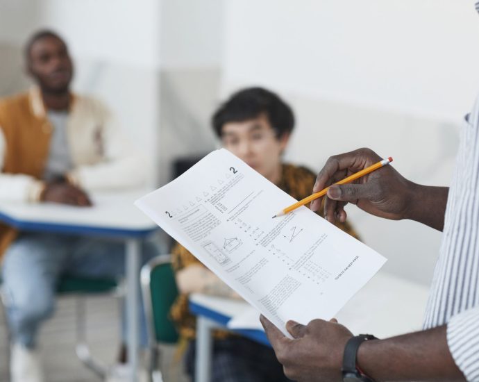 a person holding test papers