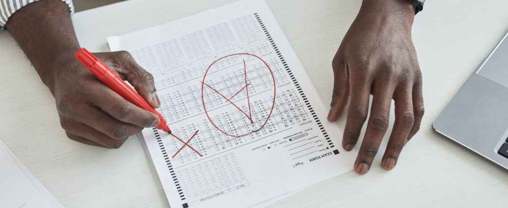 a person marking a test paper