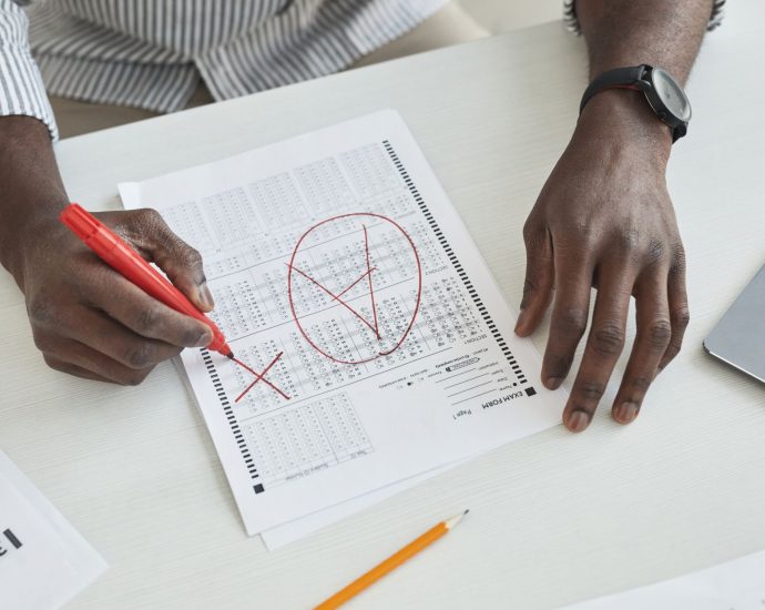 a person marking a test paper