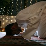man in white thobe praying